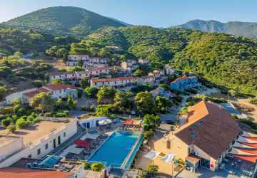 Vue aérienne de la résidence et de sa piscine, au pied des collines